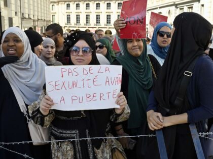 A protestor holds a sign reading "no sexuality before puberty" during a demonstration in front of the parliament of the Wallonia-Brussels Federation at the start of a plenary session, to denounce the expected adoption of the Evras decree ("L'education a la vie relationnelle, affective et sexuelle") establishing activities for relational, …