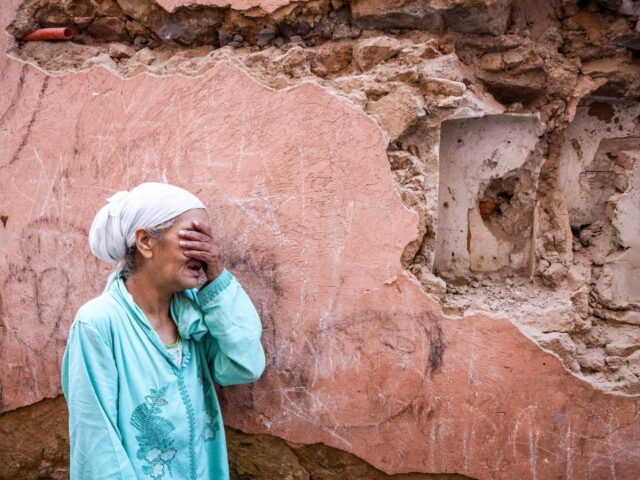 A woman reacts standing infront of her earthquake-damaged house in the old city in Marrakesh on September 9, 2023. A powerful earthquake that shook Morocco late September 8 killed more than 600 people, interior ministry figures showed, sending terrified residents fleeing their homes in the middle of the night. (Photo …