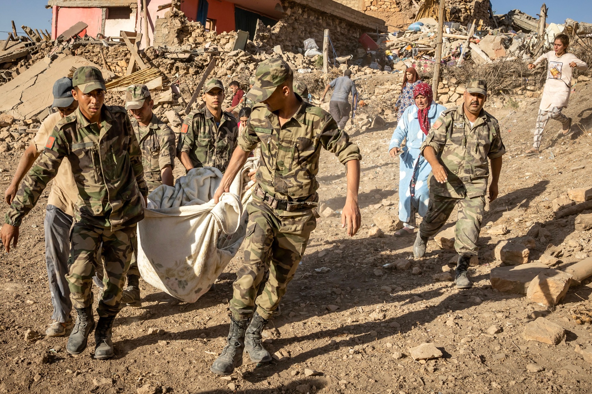 Moroccan Royal Armed Forces evacuate a body from a house destroyed in an earthquake in the mountain village of Tafeghaghte, southwest of the city of Marrakesh, on September 9, 2023. Morocco's deadliest earthquake in decades has killed more than 1,300 people, authorities said on September 9, as troops and emergency services scrambled to reach remote mountain villages where casualties are still feared trapped. (Photo by FADEL SENNA / AFP) (Photo by FADEL SENNA/AFP via Getty Images)