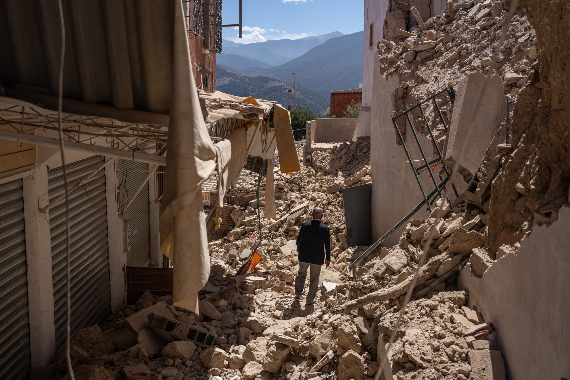 MOULAY BRAHIM, MOROCCO - SEPTEMBER 10: A man walks amongst the rubble of collapsed buildings following yesterday's earthquake, on September 10, 2023 in Moulay Brahim, Morocco. A huge earthquake measuring 6.8 on the Richter scale has hit central Morocco. Whilst the epicentre was in a sparsely populated area of the High Atlas Mountains, its effects have been felt 71km away in Marrakesh, a major tourist destination, where many buildings have collapsed and thousands of deaths have been reported. (Photo by Carl Court/Getty Images)