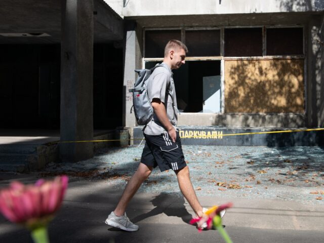 KYIV, UKRAINE - SEPTEMBER 10: A man walks past yellow tape set up after Russia launched 33