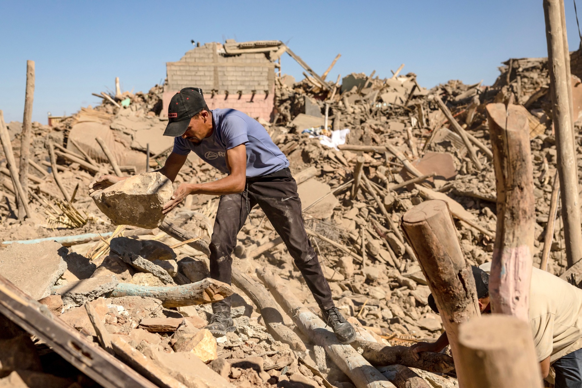 Volunteers search the rubble of collapsed houses in Tafeghaghte, 60 kilometres (37 miles) southwest of Marrakesh, on September 10, 2023, two days after a devastating 6.8-magnitude earthquake struck the country. Moroccans on September 10 mourned the victims of a devastating earthquake that killed more than 2,000 people as rescue teams raced to find survivors trapped under the rubble of flattened villages. (Photo by FADEL SENNA / AFP) (Photo by FADEL SENNA/AFP via Getty Images)