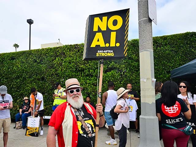 Actor, director and cinematographer Mark Gray holds a sign reading "No A.I." as