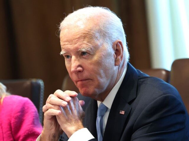 U.S. President Joe Biden listens to shouted questions regarding impeachment during a meeti