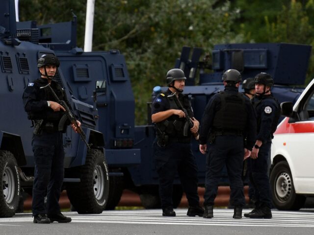 Kosovo's police officers stand guard at the entrance of the village of Banjska on Septembe