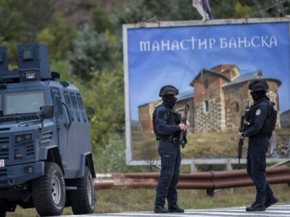 Kosovo police officers stand guard around the entrance to the village of Banjska, northern