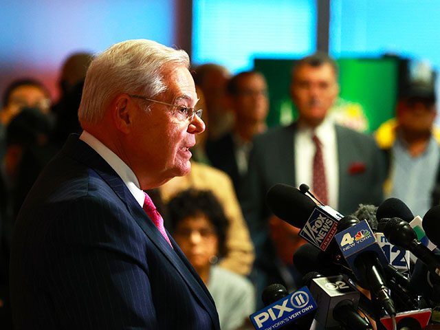 New Jersey Sen. Bob Menendez flanked by supporters is pictured during a full room press co