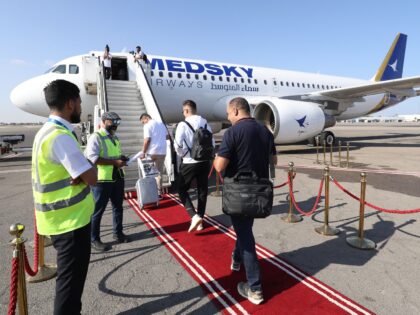 Passengers board the first flight from Tripoli to Rome on September 30, 2023 after the Italian government lifted its 10-year-old air ban on Libyan civil aviation. (Photo by Mahmud Turkia / AFP) (Photo by MAHMUD TURKIA/AFP via Getty Images)