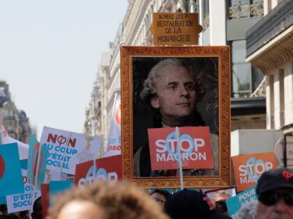 A picture depicting French president Emmanuel Macron as Louis XVI is seen during a rally called to protest against policies of the French president on the first anniversary of his election, on May 5, 2018 in central Paris. (Photo by Thomas SAMSON / AFP) (Photo credit should read THOMAS SAMSON/AFP …