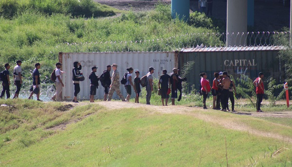 A group of migrants guide themselves to Border Patrol processing center. (Randy Clark/Breitbart Texas)