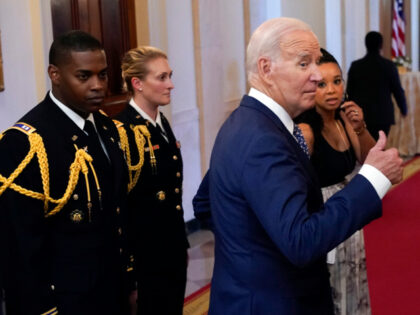 President Joe Biden turns as he exits after awarding the Medal of Honor to Capt. Larry Tay