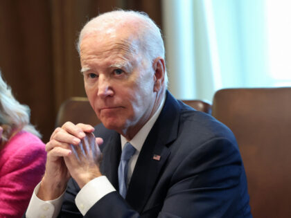 U.S. President Joe Biden listens to shouted questions regarding impeachment during a meeti