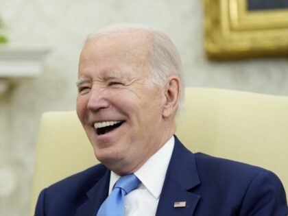 President Joe Biden laughs as he meets with British Prime Minister Rishi Sunak in the Oval