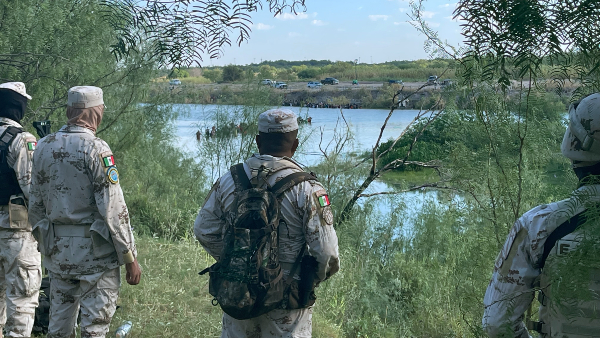 Mexican National Guard soldiers stand by and watch as migrants cross Rio Grande. (Randy Clark/Breitbart Texas)