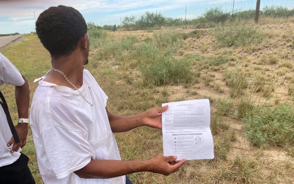 A migrant making the trek from Eagle Pass to San Antonio shows his Border Patrol release paperwork. (Randy Clark/Breitbart Texas)
