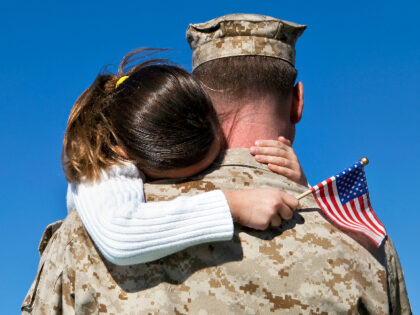Military Man Hugs Daughter - stock photo