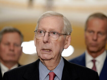 Senate Minority Leader Mitch McConnell, R-Ky., center, speaks to reporters after a policy