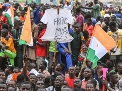 TOPSHOT - A supporter holds a t-shirt reading "France Must Go" as supporters of Niger's National Council of Safeguard of the Homeland (CNSP) protest outside the Niger and French airbase in Niamey on September 2, 2023 to demand the departure of the French army from Niger. (Photo by AFP) (Photo …