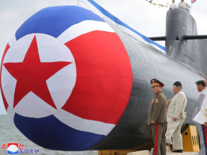 In this photo provided by the North Korean government, North Korea leader Kim Jong Un, second left, looks at what is says a new nuclear attack submarine "Hero Kim Kun Ok" at an unspecified place in North Korea Wednesday, Sept. 6, 2023. Independent journalists were not given access to cover …