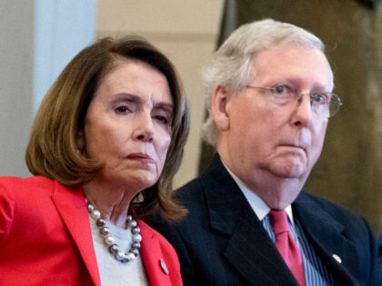 FILE - In this March 21, 2018, file photo Nancy Pelosi of Calif., and Senate Majority Leader Mitch McConnell of Ky., attend a Congressional Gold Medal Ceremony honoring the Office of Strategic Services in Emancipation Hall on Capitol Hill in Washington. Pelosi and McConnell are coming together to see if …
