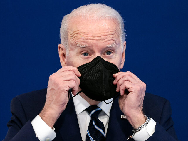 WASHINGTON, DC - JANUARY 13: U.S. President Joe Biden holds a mask as he gives remarks on