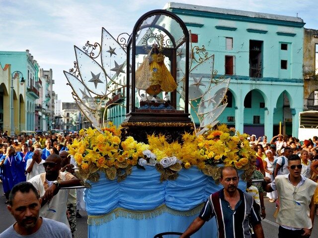 People march during a procession to celebrate the day of Our Lady of Charity of El Cobre,