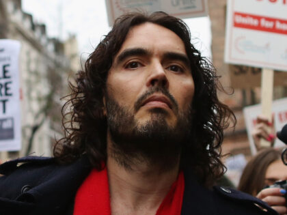 LONDON, ENGLAND - DECEMBER 01: Comedian Russell Brand joins residents and supporters from the New Era housing estate in East London as they deliver a petition to 10 Downing Street during a demonstration against US investment company Westbrook's plans to evict 93 families on December 1, 2014 in London, England. …