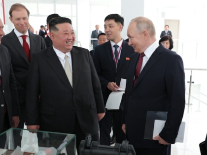 North Korea's Kim Jong-un laughs with Russian leader Vladimir Putin during a visit to far-