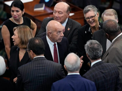 Texas state Sen. John Whitmire, D-Houston, center, talks with fellow senators during the i