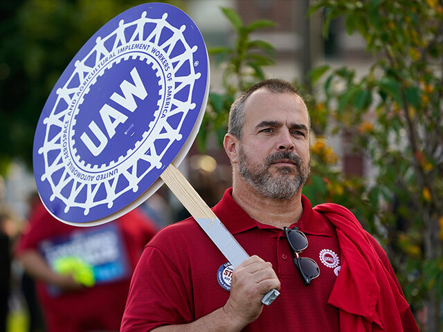 United Auto Workers members walk in the Labor Day parade in Detroit, Monday, Sept. 4, 2023