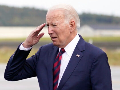 President Joe Biden returns a salute as he arrives at Joint Base Elmendorf-Richardson on M