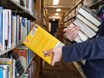 A librarian returns books to the shelves at a Boise Public Library branch on Feb. 28, 2023. Idaho lawmakers on Wednesday, March 1, 2023, considered competing bills meant to address children&apos;s access to "harmful" material in libraries. (Sarah A. Miller/Idaho Statesman/Tribune News Service via Getty Images)