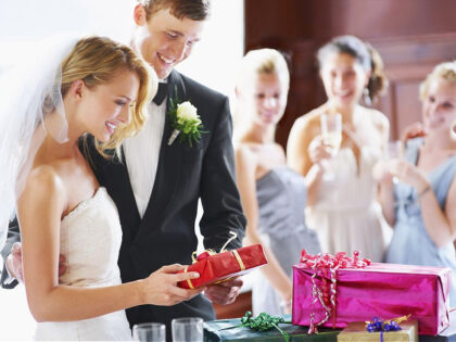 Wedding couple opening gifts - stock photo