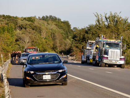 Emergency responders gather near the scene of a fatal bus crash, in Wawayanda, N.Y., Thurs
