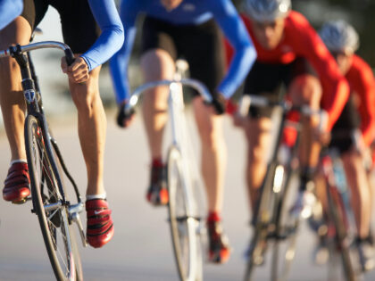 Cyclists in action, low section (focus on foreground) - stock photo