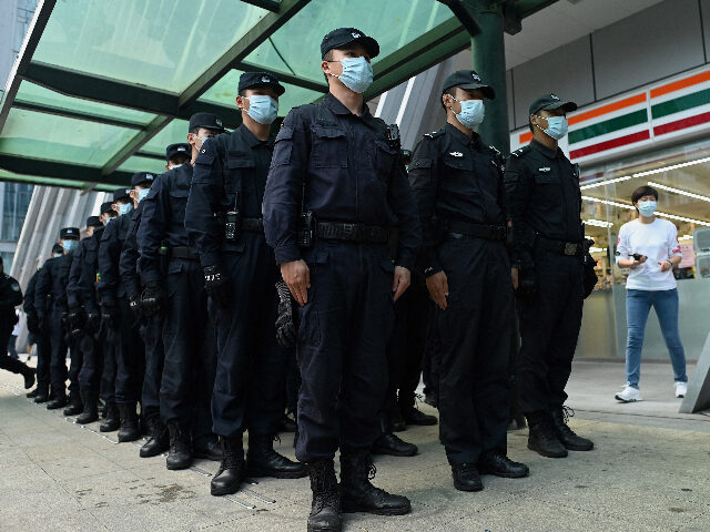 Policemen stand in formation at the Evergrande headquarters in Shenzhen, China's sout
