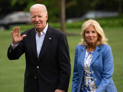 TOPSHOT - US President Joe Biden and First Lady Jill Biden walk to the White House upon ar