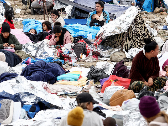 SAN DIEGO, CALIFORNIA - MAY 13: Immigrants gather at a makeshift camp stranded between bor