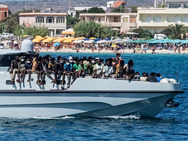 TOPSHOT - New migrants arrive on a Guardia di Finanza ship, in the harbour of Italian island of Lampedusa, on September 15, 2023. The island's reception centre, built to house fewer than 400 people, was overwhelmed with men, women and children forced to sleep outside on makeshift plastic cots, many …