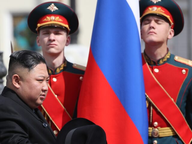 Alexander Kozlov, Russia's minister for development in the Far East, left, escorts Kim Jon