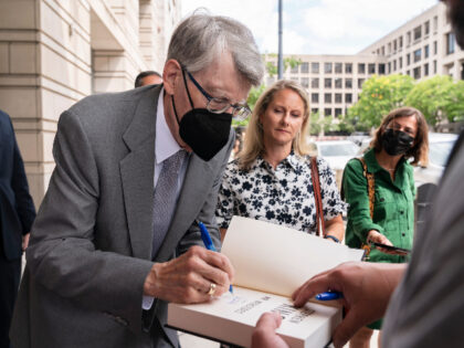 Author Stephen King signs books as he leaves federal court in Washington, after testifying