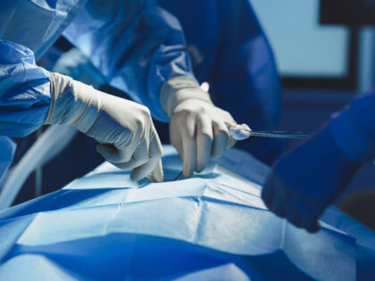 Close-up of surgeon with nurse and and assistant during operation in operating room.