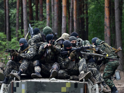 Fighters of the territorial defence unit, a support force to the regular Ukrainian army, take part in an exercise as part of the regular combat tactics classes, not far from the Ukrainian town of Bucha, Kyiv region on July 13, 2022 amid the Russian invasion of the country. (Photo by …