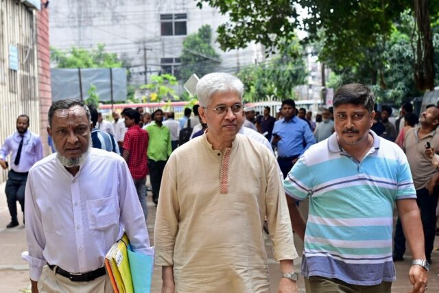 Adilur Rahman Khan (C) of the Odhikar organisation is seen outside a Bangladesh court on S