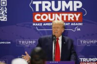 Soaring Trump snubs second Republican debate to meet auto workers