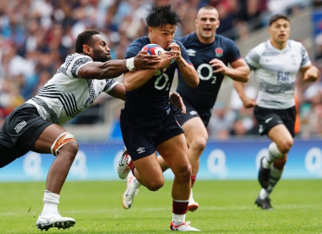 England's Marcus Smith (centre) beats Fiji's Lekima Tagitagivalu to score a try after comi
