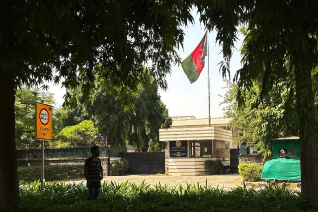 The flag of the previous Afghanistan republic flies over the entrance to the embassy in th