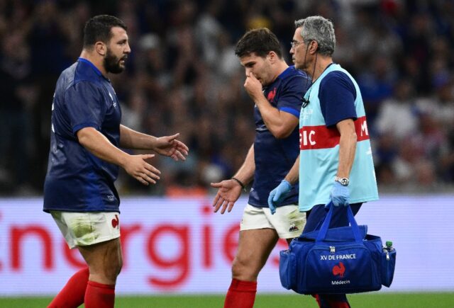 France's prop Dorian Aldegheri (L) offers a hand of support to France's scrum-half and cap