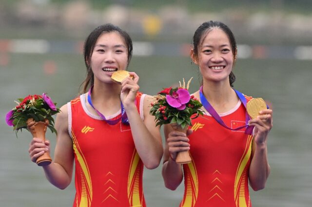 Gold medallists Zou Jiaqi and Qiu Xiuping of China celebrate their win