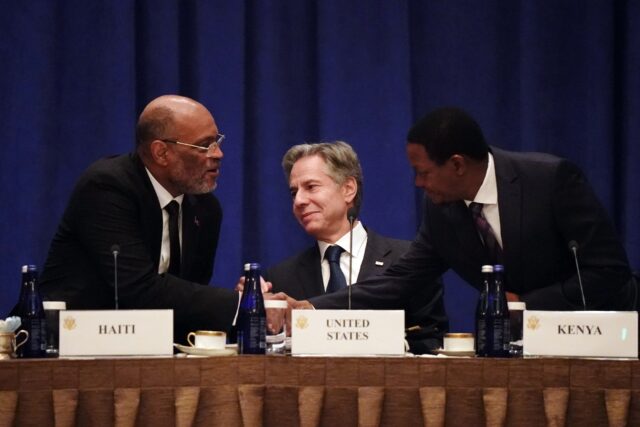Haitian Prime Minister Ariel Henry greets Kenya's top diplomat Alfred Nganga Mutua (right)
